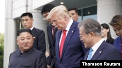 U.S. President Donald Trump, North Korean leader Kim Jong Un and South Korean President Moon Jae-in leave after a meeting at the demilitarized zone separating the two Koreas, in Panmunjom, South Korea, June 30, 2019. 