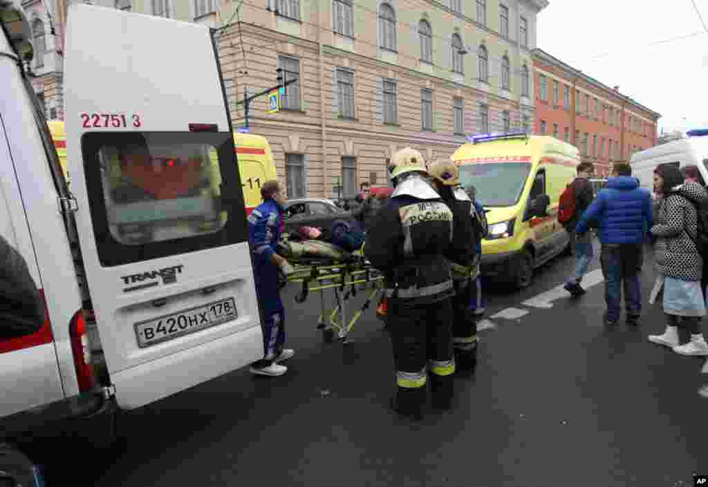 People carry a subway blast victim into an ambulance after explosion at Tekhnologichesky Institut subway station in St. Petersburg, Russia, April 3, 2017.
