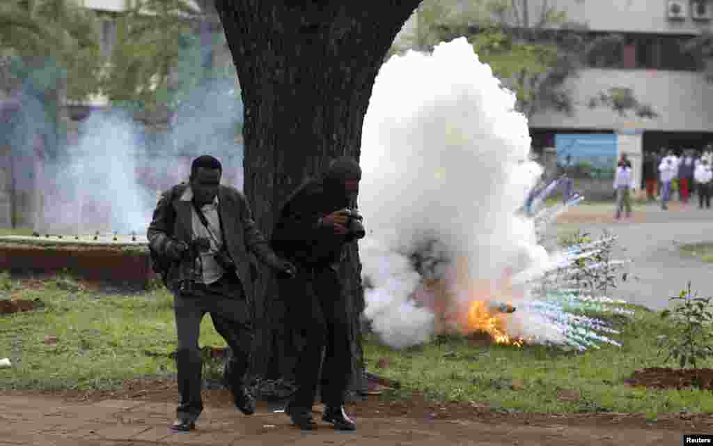 Photojournalists run away from a explosion of a tear gas canister, fired by police in a bid to disperse rioting university students in Kenya's capital Nairobi. Public university students started their protests, which are against the planned hiking of fees and lowering of maximum loan awarded to students by the Higher Education Loans Board, local media reported.