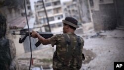A Free Syrian Army fighter fires his weapon at Syrian Army positions in Aleppo, Syria. Piece by piece, Syria's rebels are slowly starting to expand their arsenal and get their hands on more advanced weapons, September 11, 2012