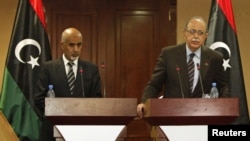 Libya's Prime Minister Abdurrahim El-Keib (R) and Head of the national assembly Mohammed Magarief attend a news conference in Tripoli, September 12, 2012.