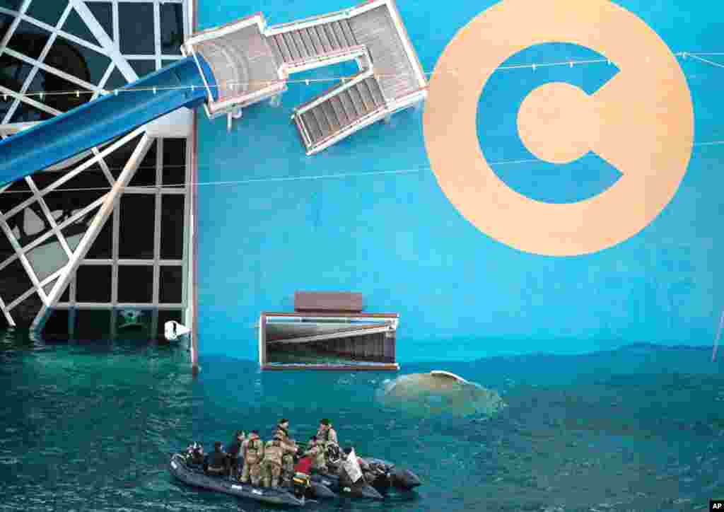 Italian naval divers exploded holes in the hull of the ship on Tuesday, to search for 29 missing passengers and crew. (AP)