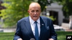 Rudy Giuliani, personal attorney for then-President Donald Trump, talks with reporters outside the White House, July 1, 2020, in Washington.