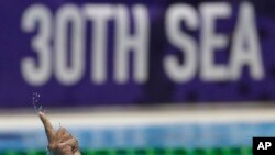 Philippines' Juan Paolo Serrano gestures after scoring a goal during their men's water polo match against Singapore at the 30th South East Asian Games in New Clark City, Tarlac province, Philippines, Nov. 29, 2019. 
