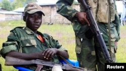 Waasi wa M23 wakiwa karibu na sehemu iliyowekwa kizuizi cha wamajeshi wa umoja wa mataifa, Kanyaruchinya, kaskazini mwa Goma. May 15,2013