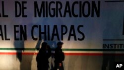 Federal police enter an immigration detention center in Tapachula, Chiapas state, Mexico, late April 25, 2019. A large group of mainly Cuban migrants escaped on foot from the immigration detention center, about half of them later returned voluntarily.