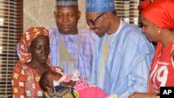 FILE - Nigeria President Muhammadu Buhari, second right, receives Amina Ali, the rescued Chibok school girl, at the Presidential palace in Abuja, Nigeria, May. 19, 2016. 