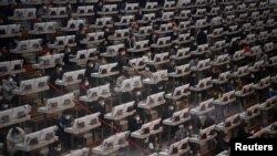 Traders wearing face masks are seen on the trading floor at a flower auction trading center following an outbreak of the novel coronavirus in the country, in Kunming, Yunnan province, China, Feb. 10, 2020.