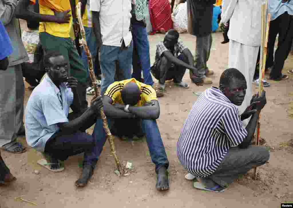 Men wait to vote at a school during a referendum in the town of Abyei, Oct. 27, 2013.