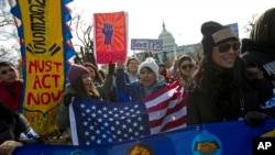 FILE - Demonstrators march during an immigration rally in support of the Deferred Action for Childhood Arrivals (DACA) and Temporary Protected Status (TPS), programs, on Capitol Hill in Washington, Dec. 6, 2017.