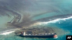 This photo taken and provided by Eric Villars shows oil leaking from the MV Wakashio, a bulk carrier ship that recently ran aground off the southeast coast of Mauritius, Aug. 7, 2020.