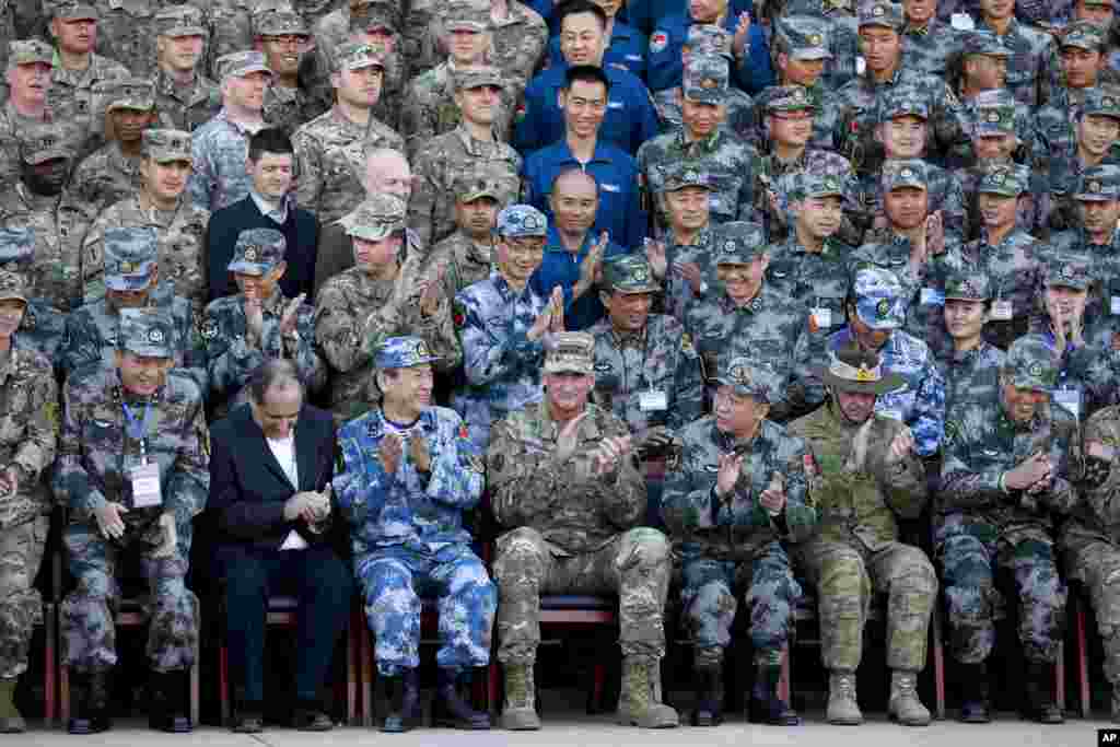 U.S. Army Pacific commander Gen. Robert Brown and Gen. Liu Xiaowu, the commander for Southern Theater Command Army of Chinese Liberation Army, applaud with their soldiers at a group photo session after conducting the U.S.-China Disaster Management Exchange (DME) drill at a PLA's training base in Kunming in southwest China's Yunnan province.