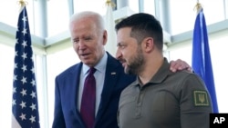 FILE - President Joe Biden, left, walks with Ukrainian President Volodymyr Zelenskyy ahead of a working session on Ukraine during the G7 Summit in Hiroshima, Japan, Sunday, May 21, 2023. (AP Photo/Susan Walsh, Pool, File)
