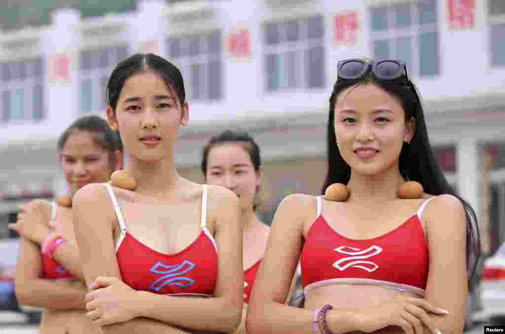 Contestants of a tourism beauty pageant balance eggs on their collarbones as they walk along the Yellow River in Jiyuan, Henan province, China, June 22, 2015. The contestants believe that if they are slim enough, their collarbones will allow them to balance the eggs securely on their bodies.