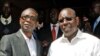 Senegalese singer Youssou N'dour shakes hands with opposition leader Macky Sall (R) during a news conference in central Dakar, Senegal, March 1, 2012.