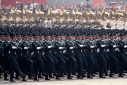 Members of a Chinese military honor guard march during the the celebration to commemorate the 70th anniversary of the founding of Communist China in Beijing, Tuesday, Oct. 1, 2019. (AP Photo/Ng Han Guan)