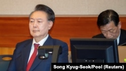 FILE - South Korea's impeached President Yoon Suk Yeol attends the hearing of his impeachment trial over his short-lived imposition of martial law, at the Constitutional Court in Seoul, Feb. 20, 2025. 