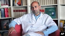 FILE - French surgeon Laurent Lantieri poses in his office at the Henri Mondor hospital in Creteil, south of Paris, July 8, 2010. 
