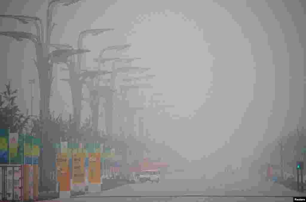 Haze blankets the National Stadium, also known as the Bird's Nest, as seen from inside the Olympic Green area during the Olympics, August 7, 2008.