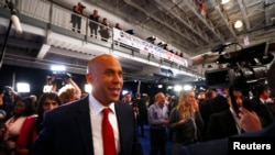 FILE - Sen. Cory Booker works his way through the spin room after the 2020 Democratic U.S. presidential debate in Houston, Sept. 12, 2019.