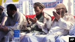 FILE - The alleged mastermind of the 2008 Mumbai attacks, Pakistani Zaki-ur-Rehman Lakhvi (C), is seen praying with others on June 28, 2008, in Muzaffarabad, capital of Pakistani Kashmir.