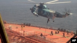 FILE - In this image from video released April 28, 2023, by the Iranian Navy, Iranian marines rappel onto the Advantage Sweet as they seize the oil tanker in the Gulf of Oman. The tanker was sailing toward international waters on July 11, 2024, tracking data show.