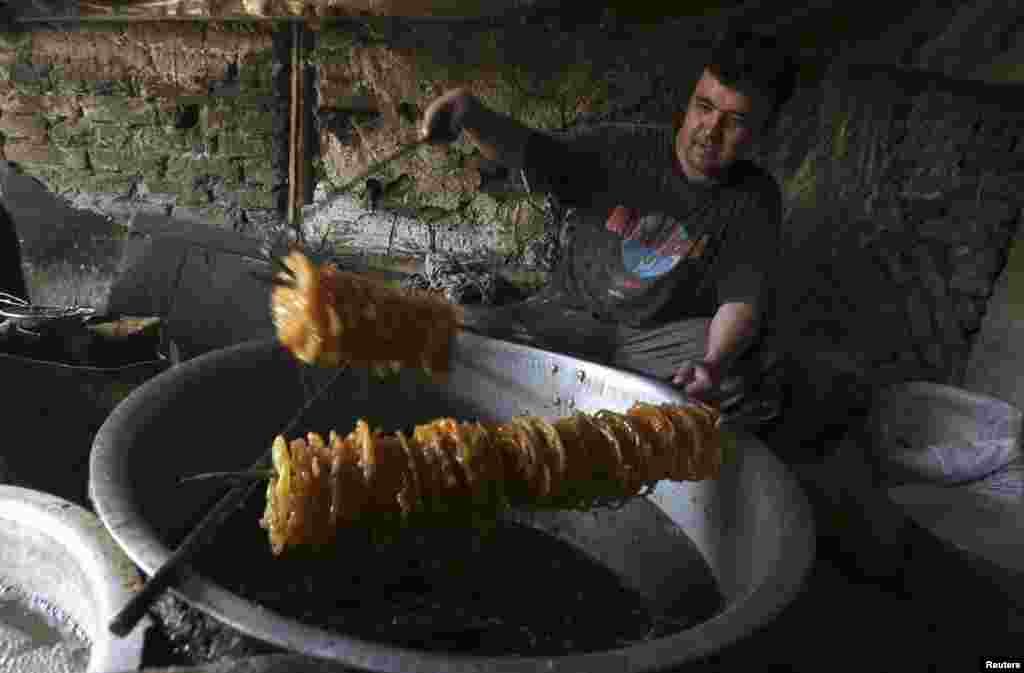 A man prepares special sweets at a small traditional factory ahead of Ramadan in Kabul, Afghanistan, July 8, 2013.