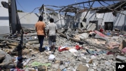 Debris covers the ground after an airstrike at a detention center in Tajoura, east of Tripoli in Libya, Wednesday, July 3, 2019. 