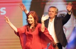 Peronist presidential candidate Alberto Fernández, behind, and running mate, former President Cristina Fernández, celebrate after the election results in Buenos Aires, Argentina, Oct. 27, 2019.