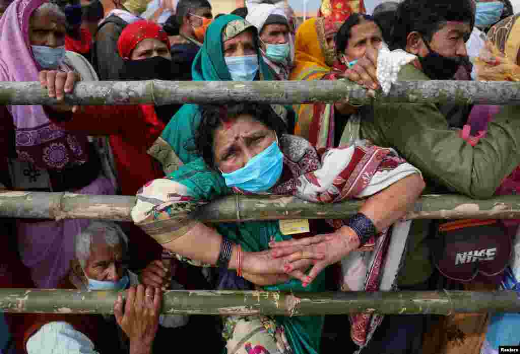 Hindu pilgrims arrive at the confluence of the river Ganges and the Bay of Bengal ahead of "Makar Sankranti" festival at Sagar Island, amidst the spread of the COVID-19 in the eastern state of West Bengal, India.