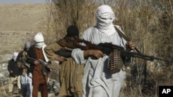 Taliban fighters pose with weapons in an undisclosed location in Nangarhar province (file photo)