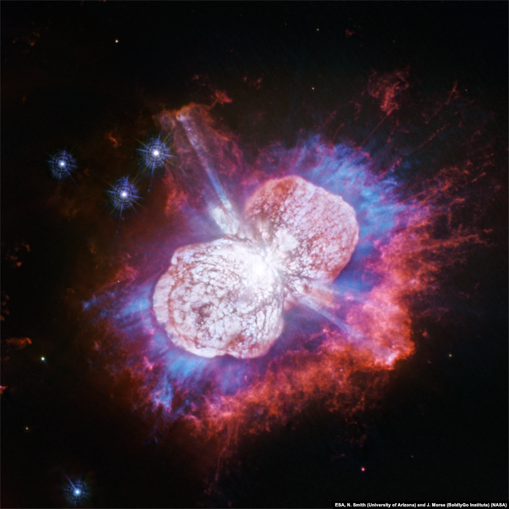 A new view from NASA's Hubble Space Telescope shows expanding gases glowing in red, white and blue of Eta Carinae, the super-massive star. Eta Carinae resides 7,500 light-years away and its slow-motion fireworks that started exploding 170 years ago and are still continuing.
