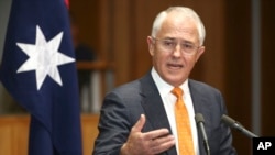 FILE - Prime Minister Malcolm Turnbull holds his hand out as he speaks to the media during a press conference at Parliament House in Canberra, Australia. Turnbull said he was made aware of Sheikh Shady Alsuleiman's controversial remarks about homosexuals during the dinner.