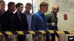 U.S. Marine Pfc. Joseph Scott Pemberton, third left, the suspect in the killing of Filipino transgender Jennifer Laude, is escorted into the courtroom for his scheduled trial, March 23, 2015, at Olongapo city, Zambales province, northwest of Manila, Philippines.