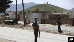 Le personnel de sécurité afghan monte la garde sur le site d'un attentat-suicide à la bombe dans la banlieue de Kaboul, en Afghanistan, le mercredi 29 avril 2020. 