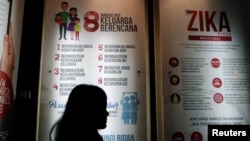 FILE - A woman passes a poster explaining about the Zika virus at the Ministry of Health office in Jakarta, Indonesia, Sept. 2, 2016. Vietnam's health ministry announced Nov. 2, 2016, a large increase of Zika cases. 