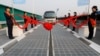 Sebuah kendaraan di jalur panel surya saat peresmian di Jinan, Provinsi Shandong, China, 28 Desember 2017. (Foto: Reuters)