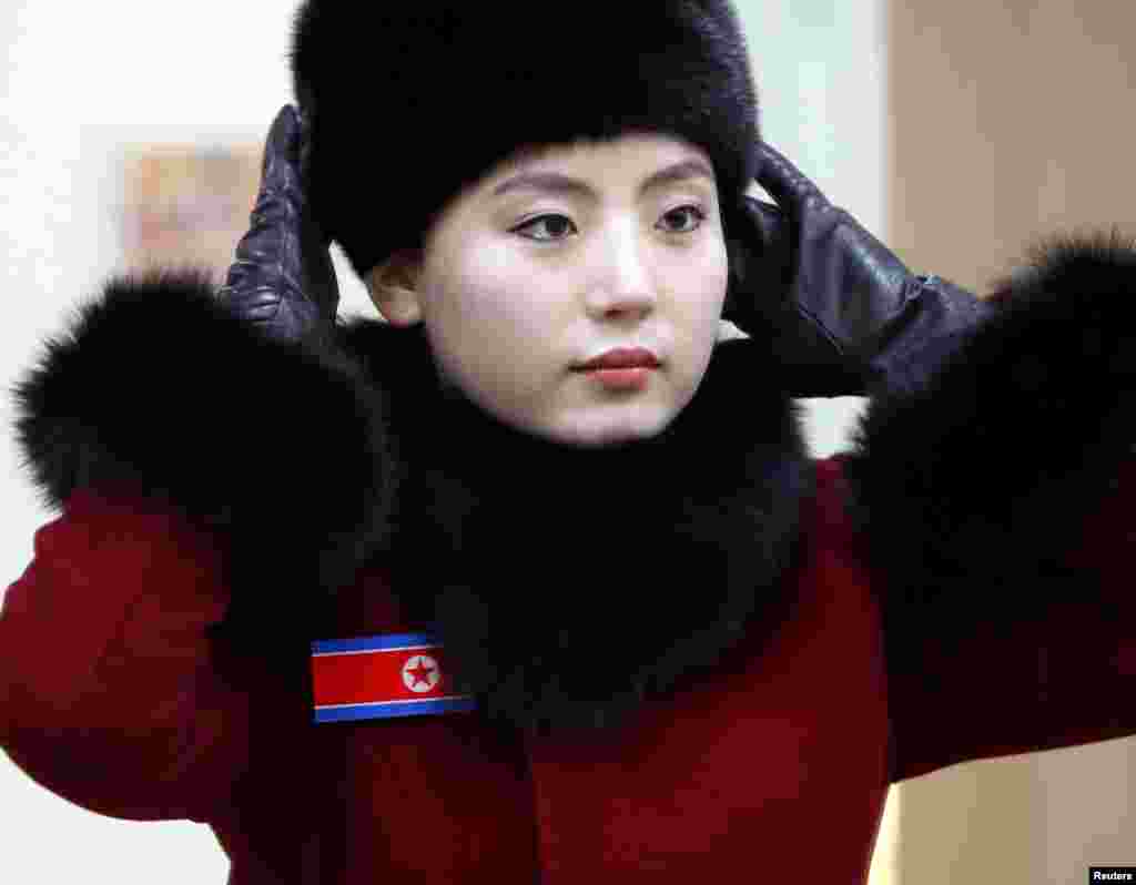 A members of North Korean cheering squad looks at herself in a mirror in a ladies' room in Gapyeong, South Korea.