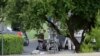 FILE - Police appear to set up a remotely operated robot during a stand-off with a gunman barricaded inside a van at a Jack in the Box restaurant in Hutchins, Texas. 
