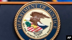 FILE - The U.S. Department of Justice seal is seen at the DOJ office in Washington on May 16, 2023. The DOJ said on Sept. 6, 2024, that Canada had arrested a Pakistani man who was allegedly planning an attack in New York.