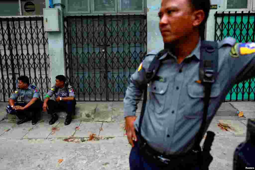 Police officers guard a Muslim residential area in Mandalay, Myanmar, July 3, 2014.