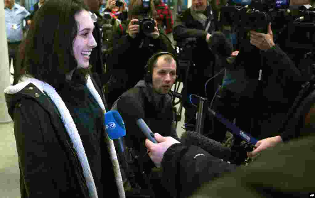 Greenpeace activist Alexandra Harris, who was one of the 30 crew arrested by Russian authorities, speaks to the media after arriving in London, England, Dec. 27, 2013.