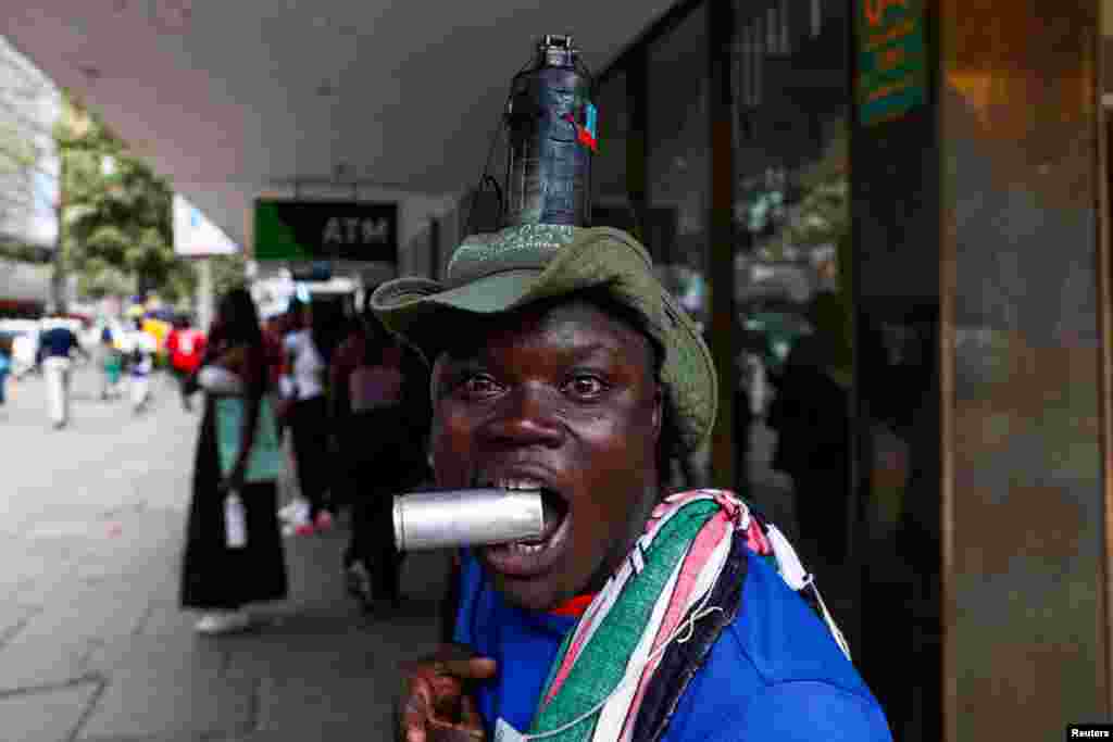 A man has a grenade attached to his head as activists and civil society members participate in a nationwide march titled "End Femicide Kenya" to raise awareness about gender-based violence (GBV) in downtown Nairobi.