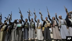 FILE - Shi'ite Houthi tribesmen hold their weapons as they chant slogans during a tribal gathering showing support for the Houthi movement, in Sana'a, Yemen, Sept. 21, 2019.