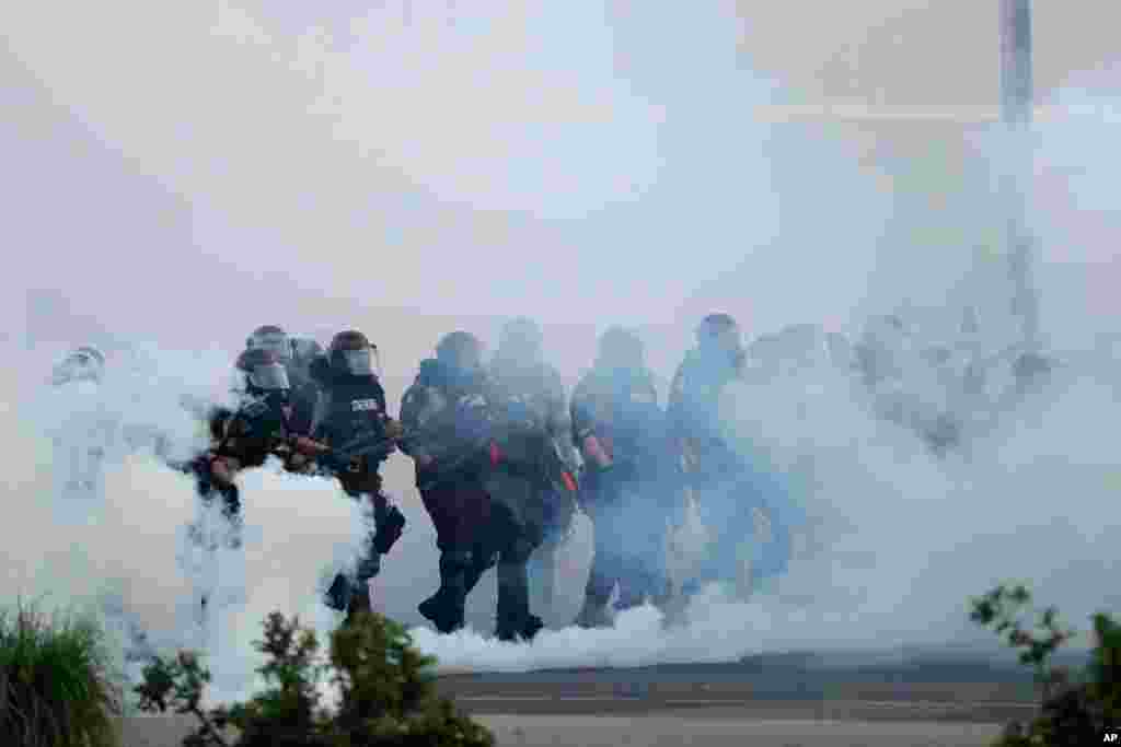 Police move toward demonstrators, May 31, 2020, in Minneapolis.