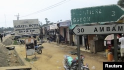 FILE - Signs are seen on the border with Equatorial Guinea and Gabon in Kye-Ossi, Cameroon, May 23, 2015.