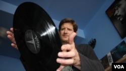 Kevin Stuart about to put another vinyl record on the turntable inside his Record Mad store in Johannesburg. (Darren Taylor for VOA News)