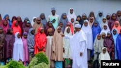 Nigeria's President Muhammadu Buhari meets with some of the newly released Dapchi schoolgirls in Abuja, Nigeria, March 23, 2018.