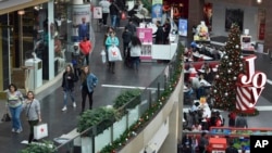 FILE- People shop at the Pentagon City Mall in Arlington, Virginia, Dec. 22, 2017.