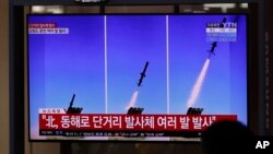 People watch a TV screen airing reports about North Korea's firing missiles with file images of missiles at the Seoul Railway Station in Seoul, South Korea, April 14, 2020.